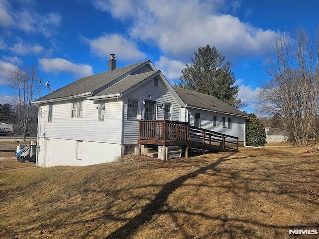 rear view of property with a wooden deck