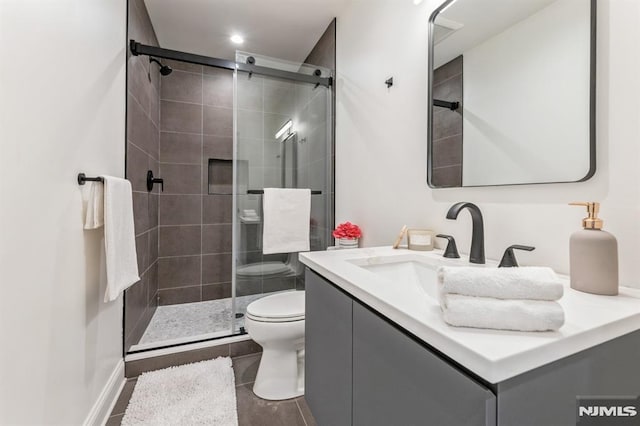 bathroom with vanity, toilet, and walk in shower