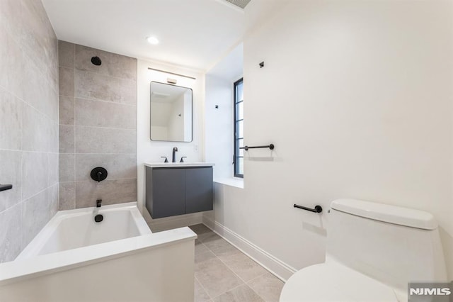 full bathroom with tiled shower / bath, tile patterned flooring, vanity, and toilet