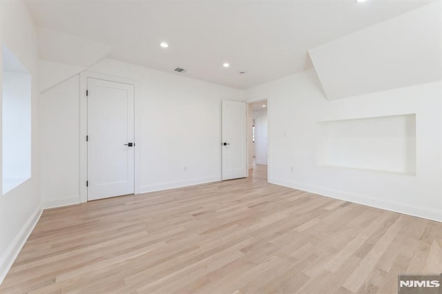 additional living space featuring light wood-type flooring