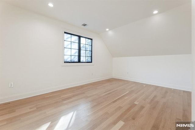 bonus room featuring light wood-type flooring and lofted ceiling