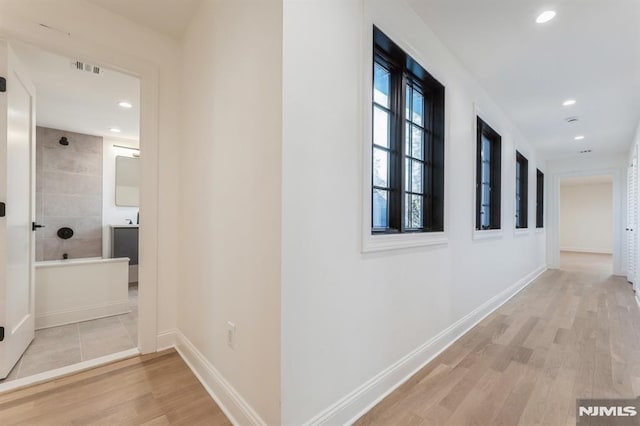 hallway with light hardwood / wood-style flooring