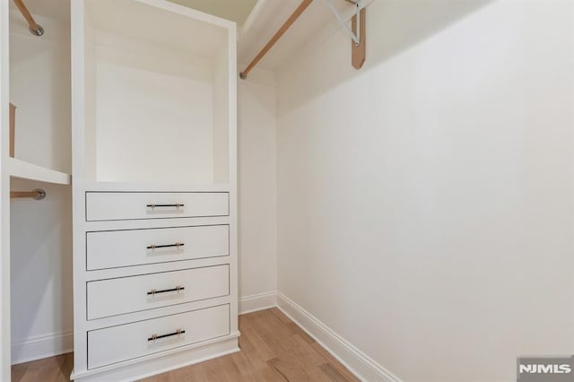 walk in closet featuring light wood-type flooring