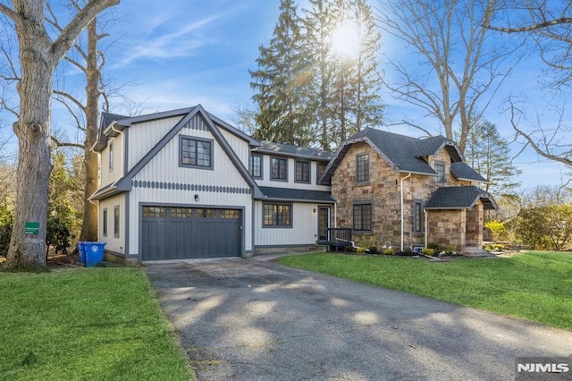 view of front of house with a garage and a front lawn