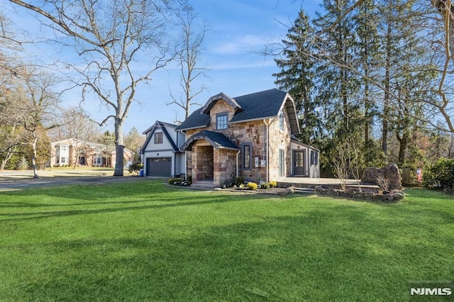 view of front of house with a front yard and a garage