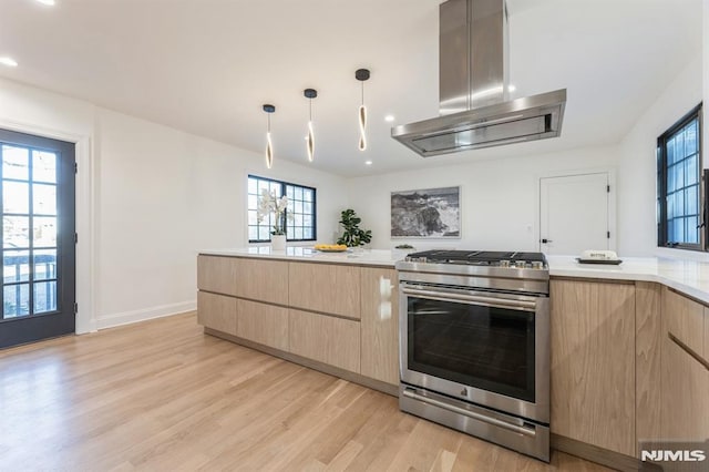 kitchen with pendant lighting, gas stove, island exhaust hood, and light brown cabinetry