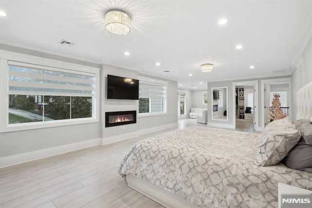 bedroom featuring multiple windows, a chandelier, and ornamental molding