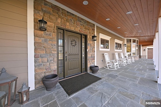 view of exterior entry featuring a porch