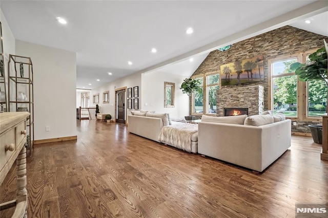 living room featuring a fireplace, wood-type flooring, and vaulted ceiling