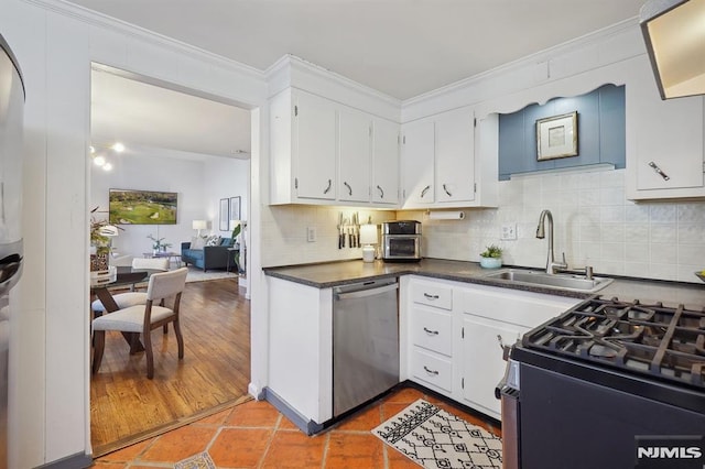 kitchen featuring sink, stainless steel appliances, tile patterned flooring, and white cabinets