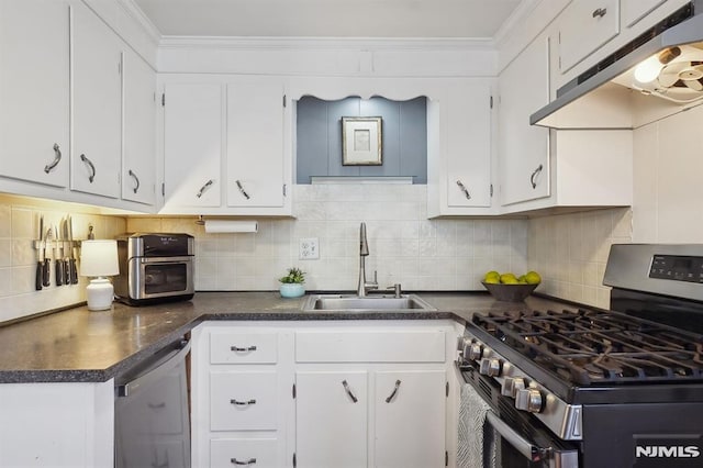 kitchen featuring stainless steel appliances, white cabinets, and tasteful backsplash