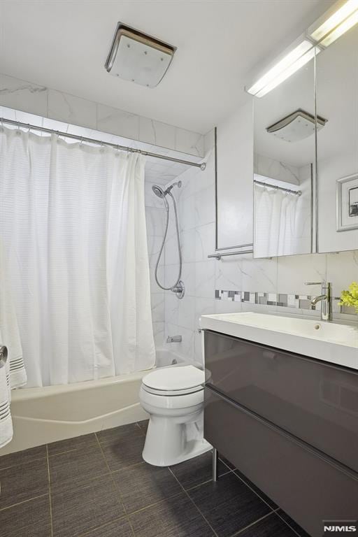 full bathroom with tile patterned flooring, shower / bath combination with curtain, vanity, and toilet