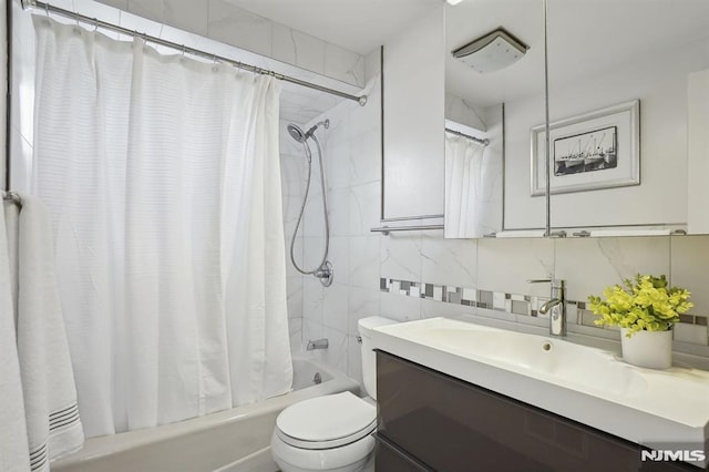 full bathroom featuring toilet, shower / bath combination with curtain, tile walls, backsplash, and vanity