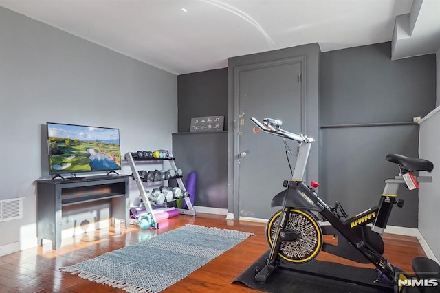 workout area featuring hardwood / wood-style flooring