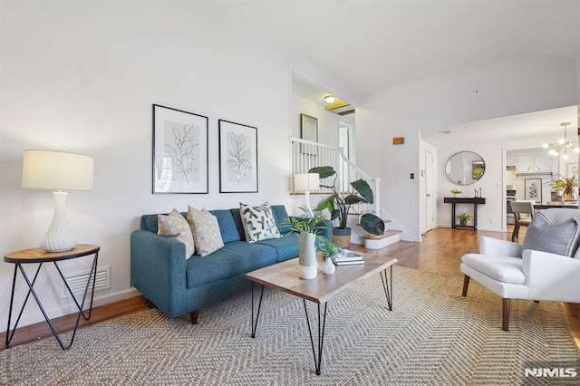 living room featuring a chandelier and wood-type flooring