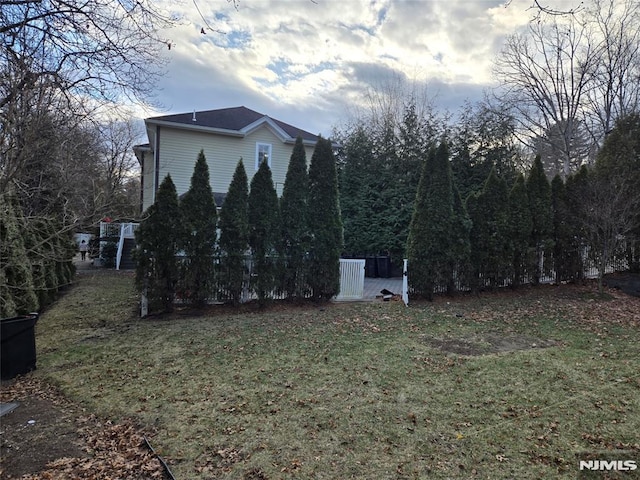 view of side of home featuring a lawn