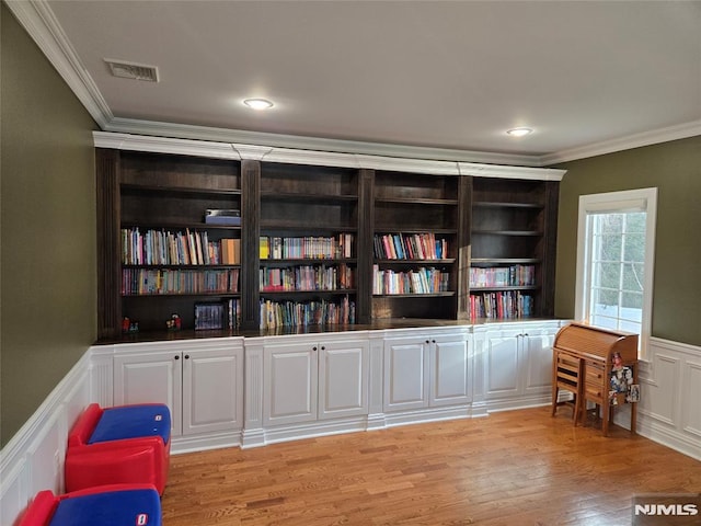 interior space featuring light hardwood / wood-style floors and ornamental molding