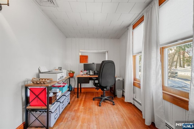 office featuring a baseboard heating unit and light hardwood / wood-style floors