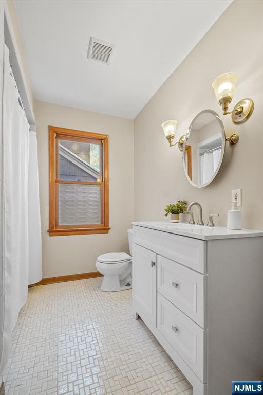 bathroom with vanity and toilet