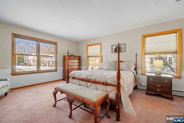 carpeted bedroom with multiple windows and a baseboard heating unit