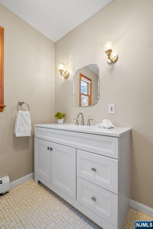 bathroom featuring a baseboard radiator and vanity