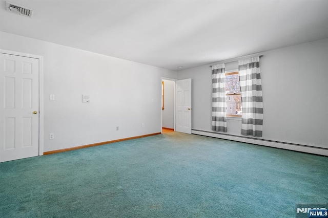 empty room with a baseboard heating unit and carpet