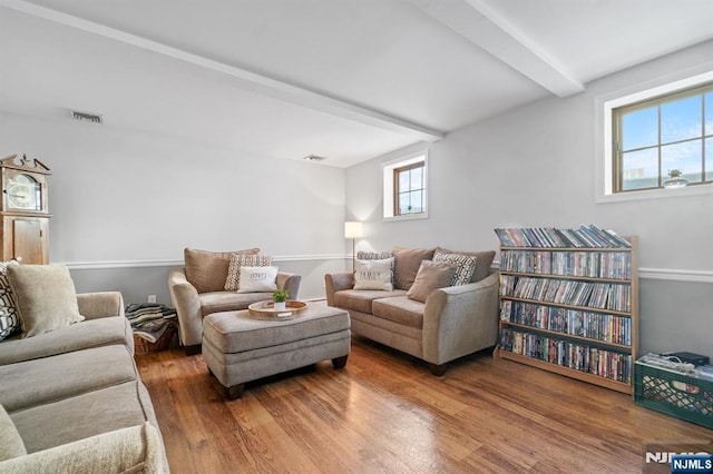 living room with beam ceiling and hardwood / wood-style floors