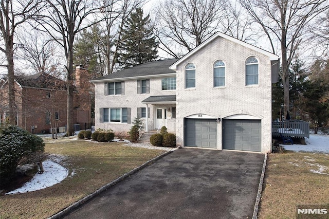 view of front facade with a garage and a front lawn