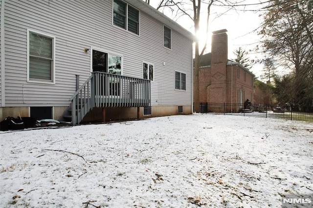 view of snow covered rear of property