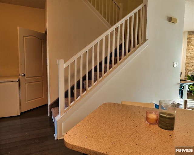 stairs featuring wood-type flooring