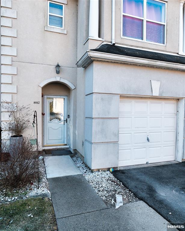 view of exterior entry featuring a garage