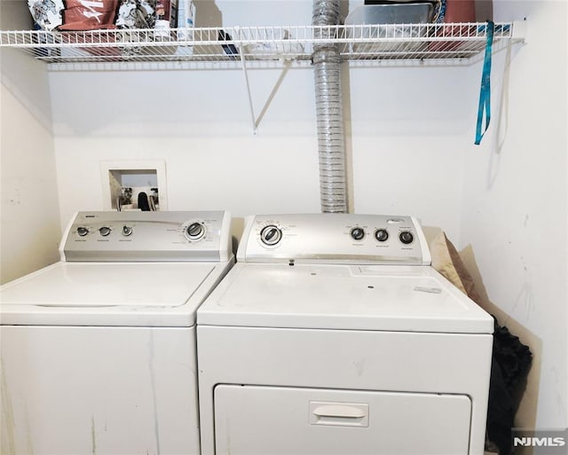 clothes washing area featuring washing machine and dryer