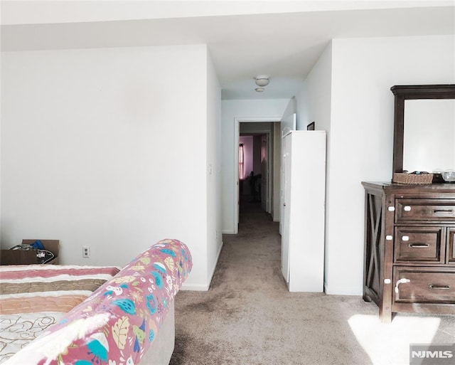 bedroom featuring light carpet