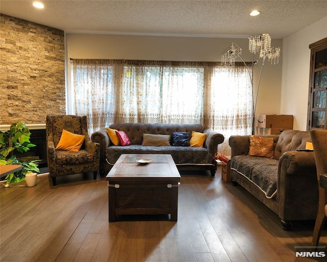 living room with wood-type flooring and a textured ceiling