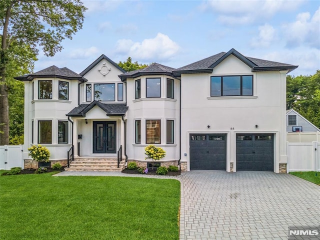 view of front of property featuring a front yard and a garage