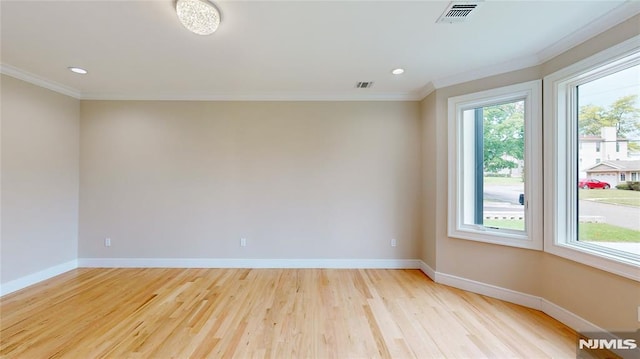 unfurnished room featuring crown molding and light hardwood / wood-style flooring