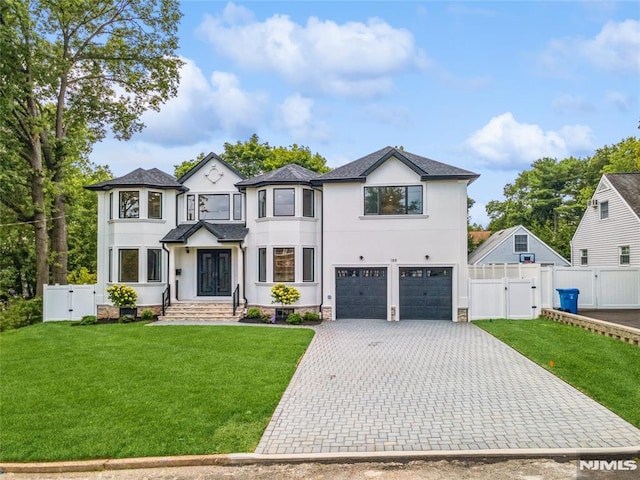 view of front of house with a front yard and a garage