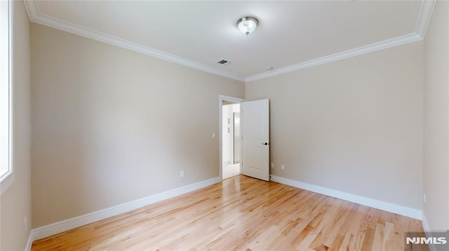 unfurnished room with light hardwood / wood-style flooring and crown molding