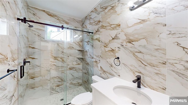 bathroom featuring tile walls, toilet, a shower with door, and sink