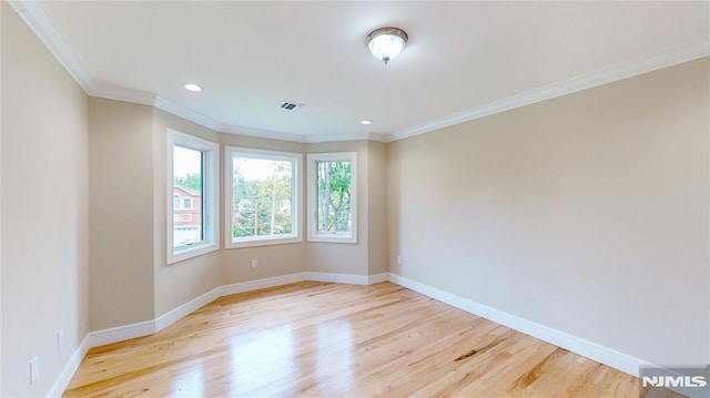 unfurnished room featuring light hardwood / wood-style flooring and crown molding