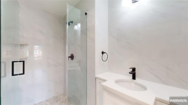 bathroom featuring vanity and walk in shower