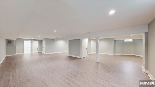 basement with light hardwood / wood-style floors