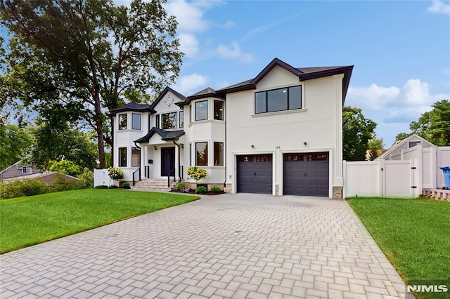 view of front of home featuring a garage and a front yard