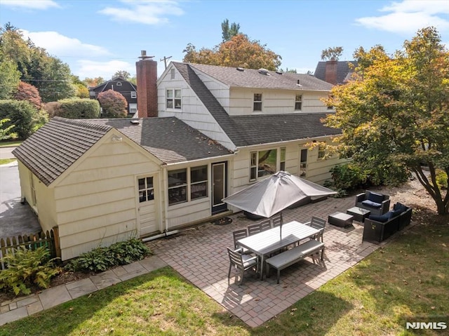 back of house with a patio, a lawn, and an outdoor living space