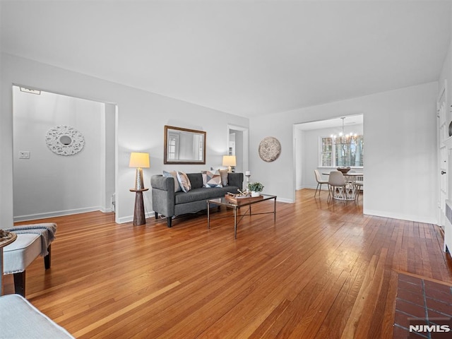 living room featuring a chandelier and wood-type flooring