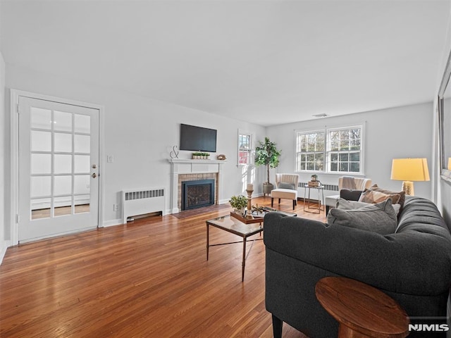 living room with radiator heating unit and wood-type flooring