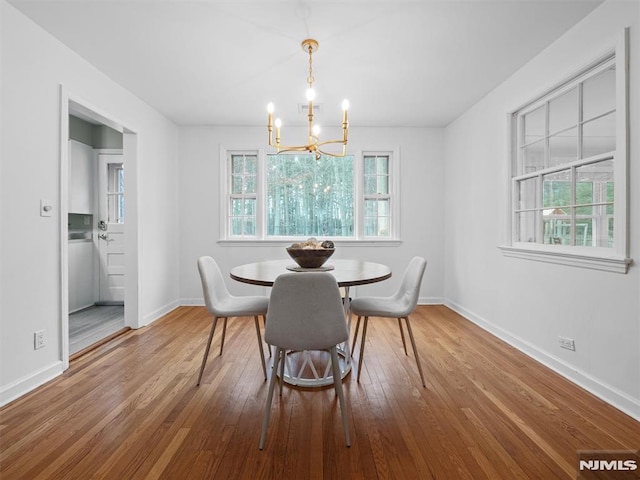 dining space with a chandelier and hardwood / wood-style flooring