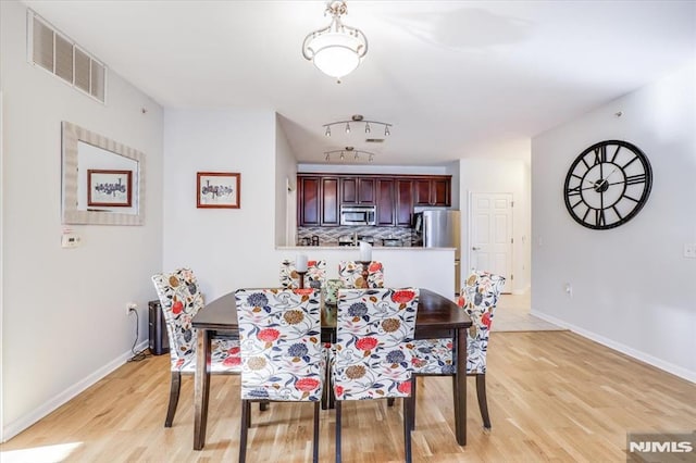 dining area with light hardwood / wood-style flooring