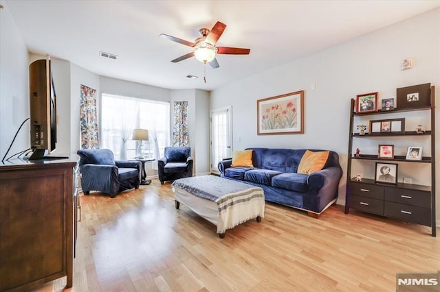 living room featuring ceiling fan and light hardwood / wood-style floors