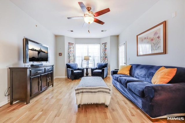 living room featuring light hardwood / wood-style floors and ceiling fan